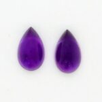 Two Tear Drops Shaped Violet Color Stone on a Background