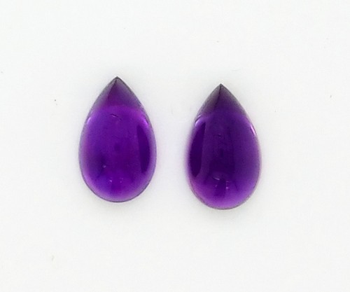 Two Tear Drops Shaped Violet Color Stone on a Background